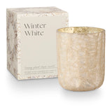 Candle with decorative box labeled 'Winter White' on a white background. Available at Be Charmed