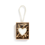 Heart-shaped token in a box with a white background. Available at Be Charmed