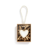 Heart-shaped token in a box with a white background. Available at Be Charmed