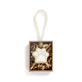 Mini Token shaped like a paw print in a box with a string on a white background. Available at Be Charmed