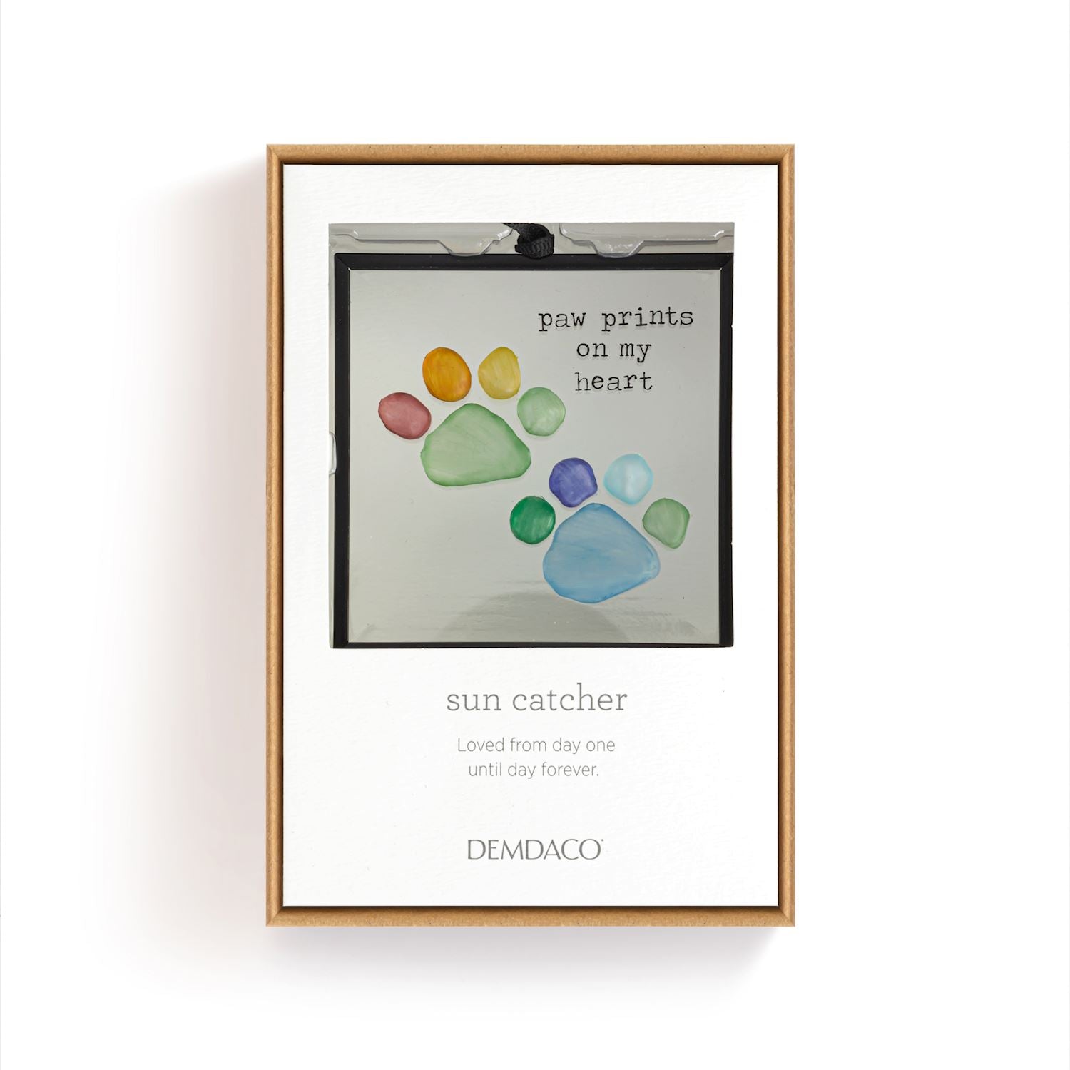 Coxed suncatcher with colorful paw prints and text on a white background. Available at Be Charmed