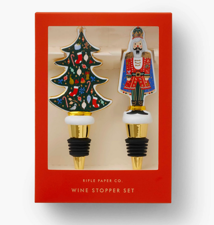 Boxed Nutcracker and Christmas tree porcelain wine stoppers with gold accents—Available at Be Charmed