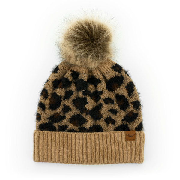 Tan Snow Leopard Pom Hats – stylish knit winter hats with bold leopard print, fluffy pom, and cozy fit for warmth and flair, available at Be Charmed