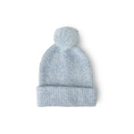 Light blue knit beanie with a pom-pom on a white background. Available at Be Charmed