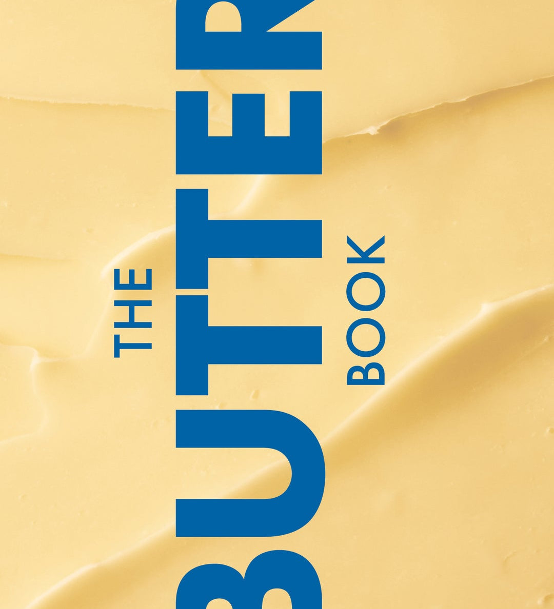 Book cover of 'The Butter Book' with blue text on a yellow background. Available at Be Charmed