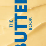 Book cover of 'The Butter Book' with blue text on a yellow background. Available at Be Charmed