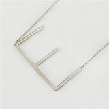 E Silver Initial Necklace by CAI, 16" chain with 2" extension, featuring a sleek silver-plated initial pendant, available at Be Charmed.