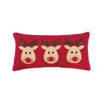 A festive red winter lumbar accent pillow featuring three cute holiday reindeers in applique detail, available at Be Charmed.