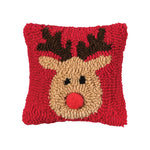 A festive red winter lumbar accent pillow featuring a cute holiday reindeer in hooked detail, available at Be Charmed.