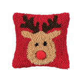 A festive red winter lumbar accent pillow featuring a cute holiday reindeer in hooked detail, available at Be Charmed.