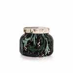 Capri Blue Crystal Pine candle in a decorative pattern jar with green leaf pattern on a white background. Available at Be Charmed. 