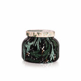 Capri Blue Crystal Pine candle in a decorative pattern jar with green leaf pattern on a white background. Available at Be Charmed. 