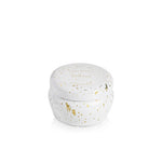 Capri Blue volcano glimmer mini tin candle in a white container with gold speckles on a white background. Available at Be Charmed. 