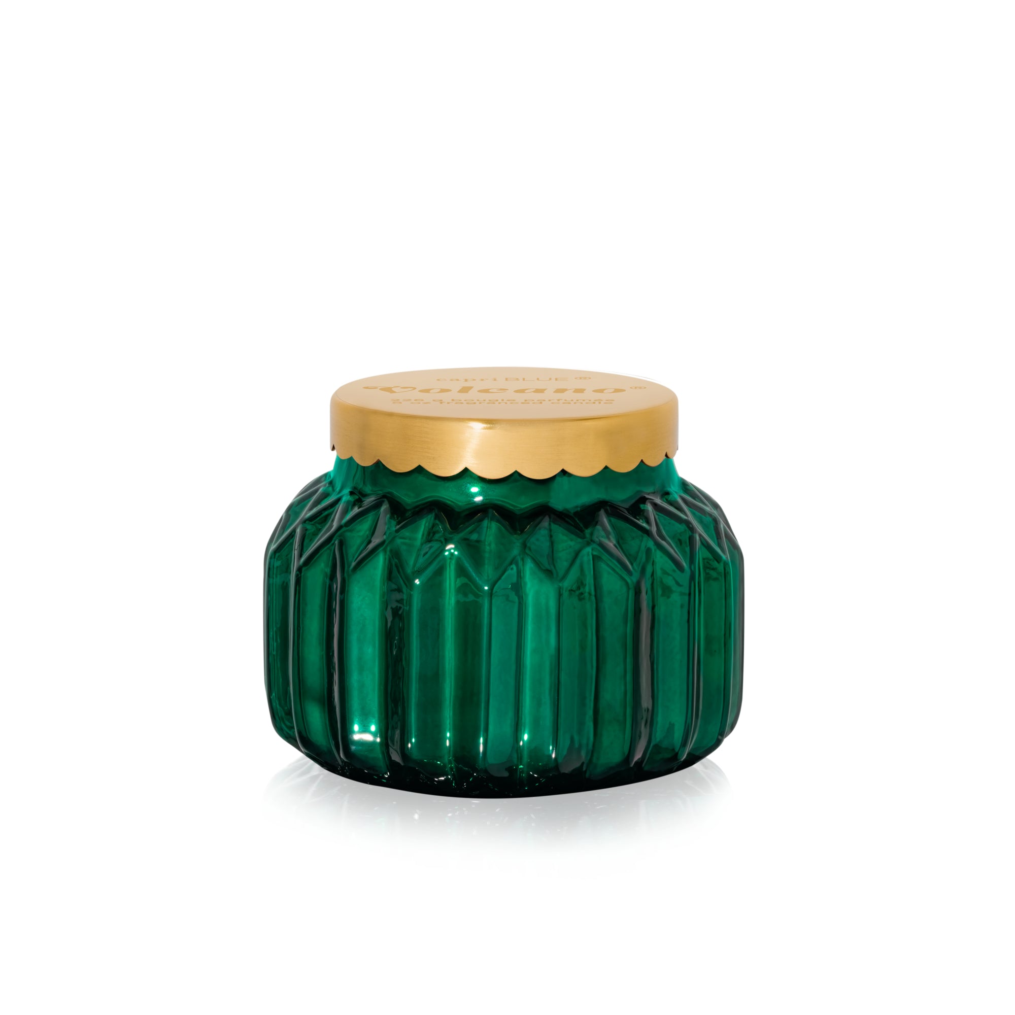 Capri Blue volcano green glass jar candle with a gold lid on a white background. Available at Be Charmed. 