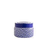  Volcano Printed Travel Tin Candle by Capri Blue—8.5 oz travel tin with white/blue print, soy-blend wax, burns up to 40 hrs, available at Be Charmed.