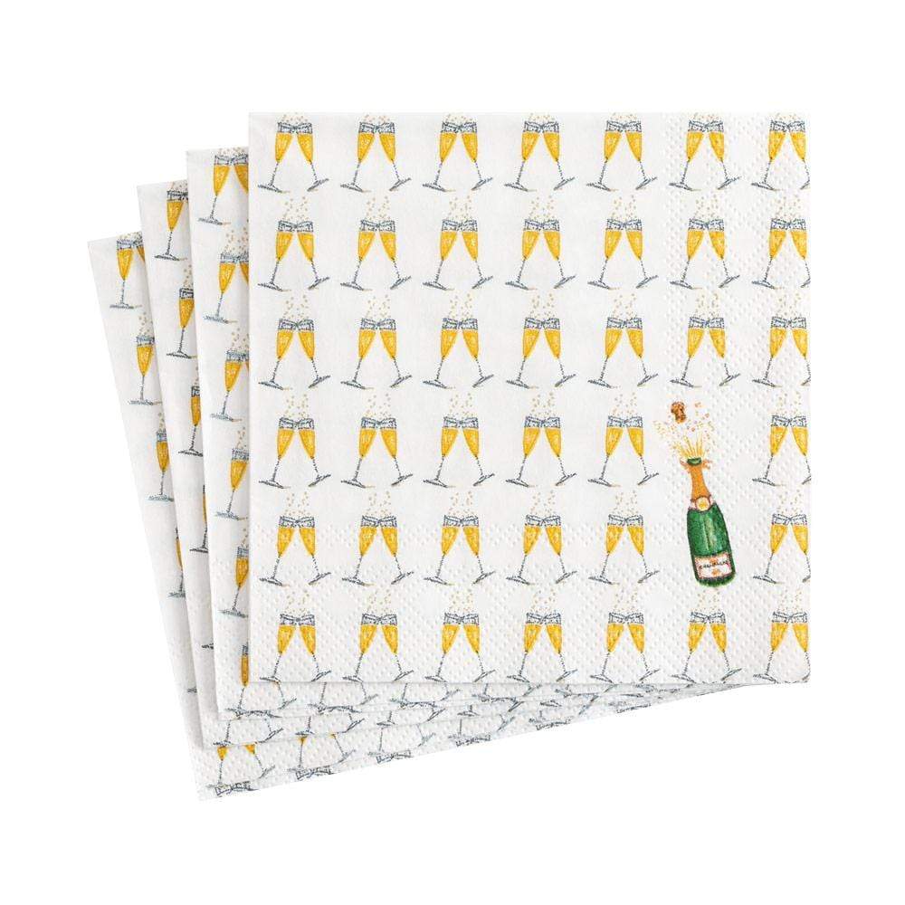 Folded napkins with champagne glass pattern on a white background. Available at Be Charmed