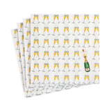 Folded napkins with champagne glass pattern on a white background. Available at Be Charmed