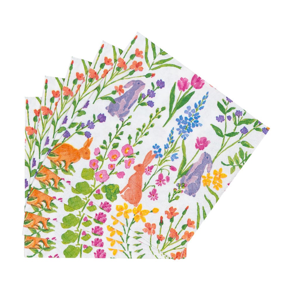 Napkins with colorful floral and bunny pattern on a white background. Available at Be Charmed