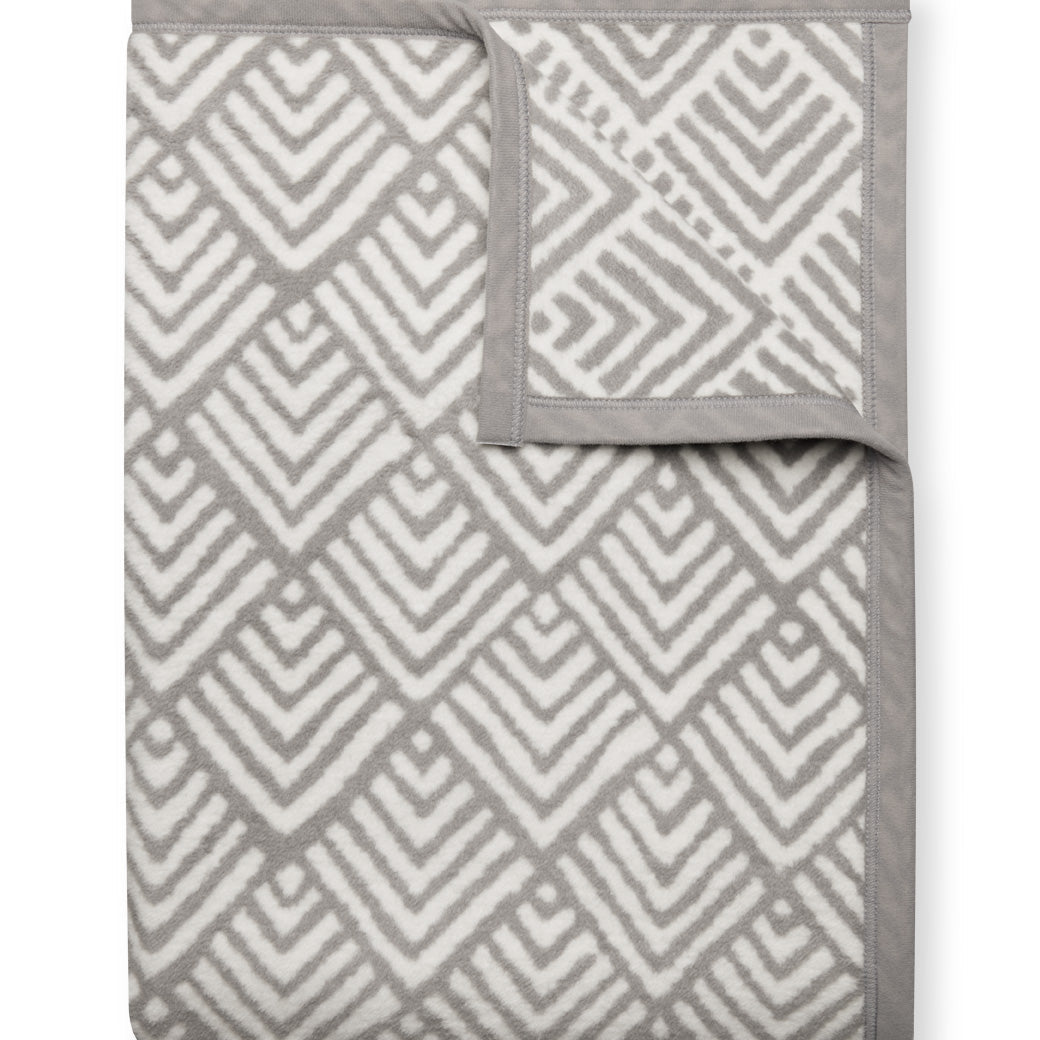 Oyster Cove Grey ChappyWrap Blanket featuring a classic diamond weave pattern, made from a cotton-blend fabric for exceptional softness and durability—ideal for cozy nights or elegant home décor. Available at Be Charmed.