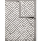 Oyster Cove Grey ChappyWrap Blanket featuring a classic diamond weave pattern, made from a cotton-blend fabric for exceptional softness and durability—ideal for cozy nights or elegant home décor. Available at Be Charmed.