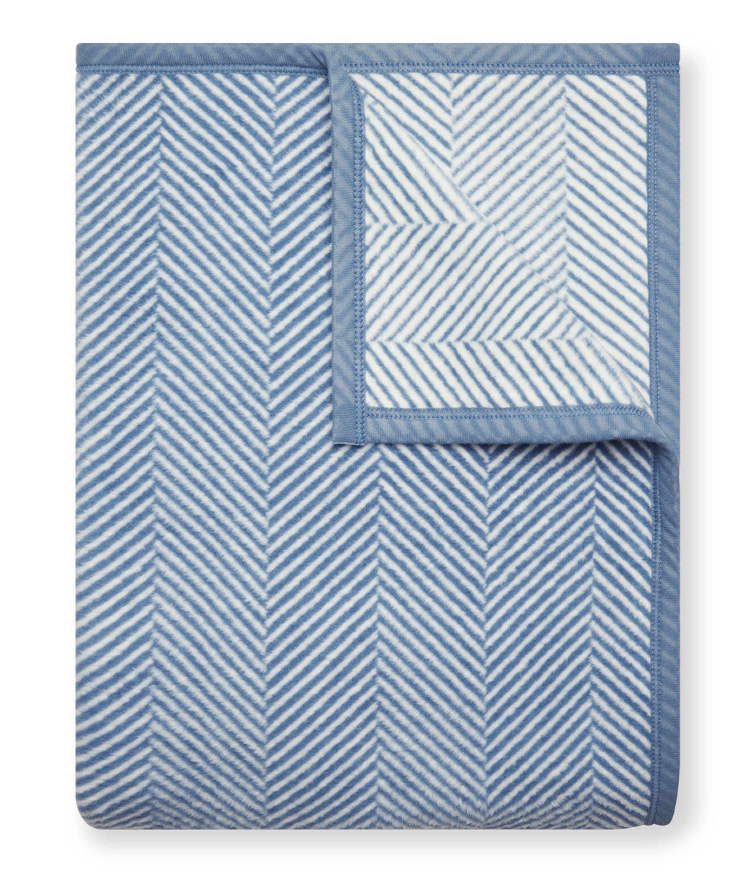 Cornflower Chappy Wrap Harborview Herringbone Blanket – Original size throw in a classic light grey herringbone pattern. Plush, durable, and machine washable. A cozy neutral accent for the home or perfect gift. Available at Be Charmed.
