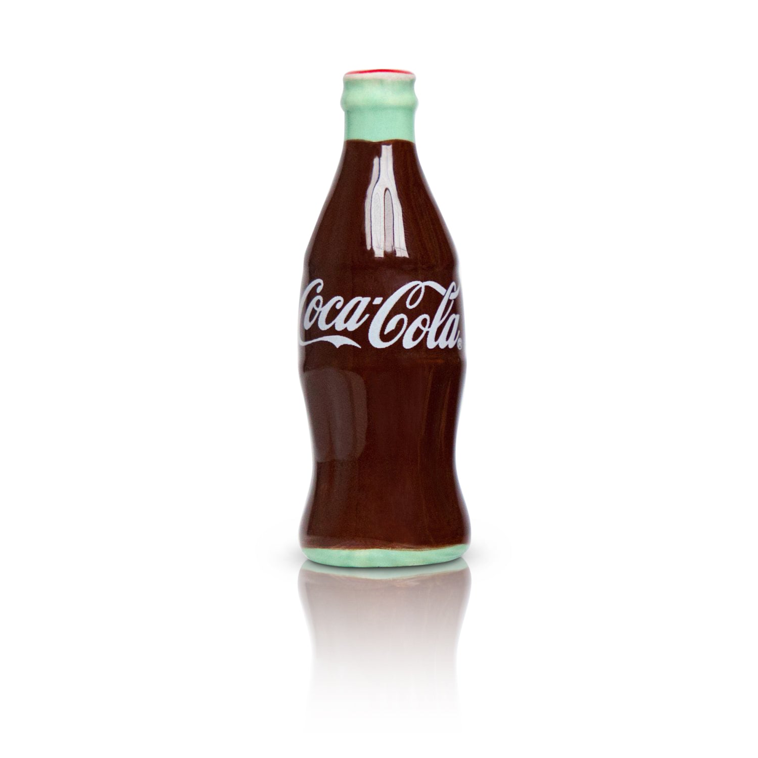Coca-Cola bottle with a white label on a white background. Avaiable at Be Charmed