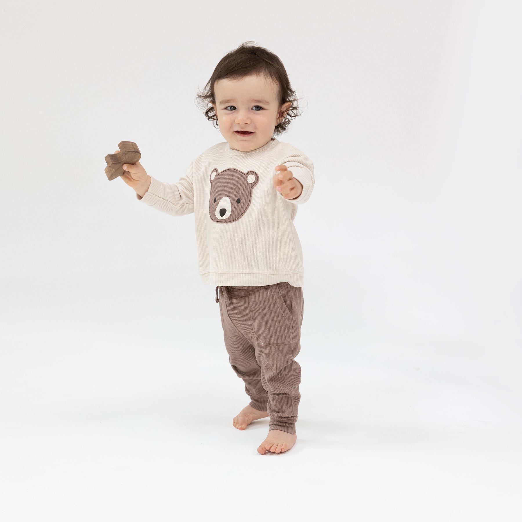 Child wearing Angel Dear Baby Bear Sweatshirt and Jogger Set with cozy fabric and bear design, available at Be Charmed.