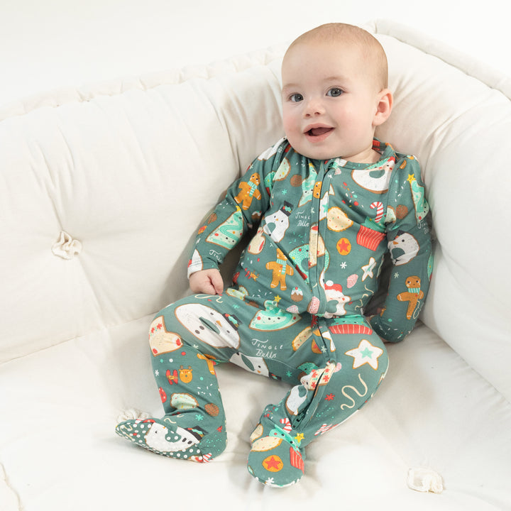 Baby wearing Angel Dear Christmas Treats 2-Way Zipper Footie with soft fabric and festive holiday treat print, available at Be Charmed.