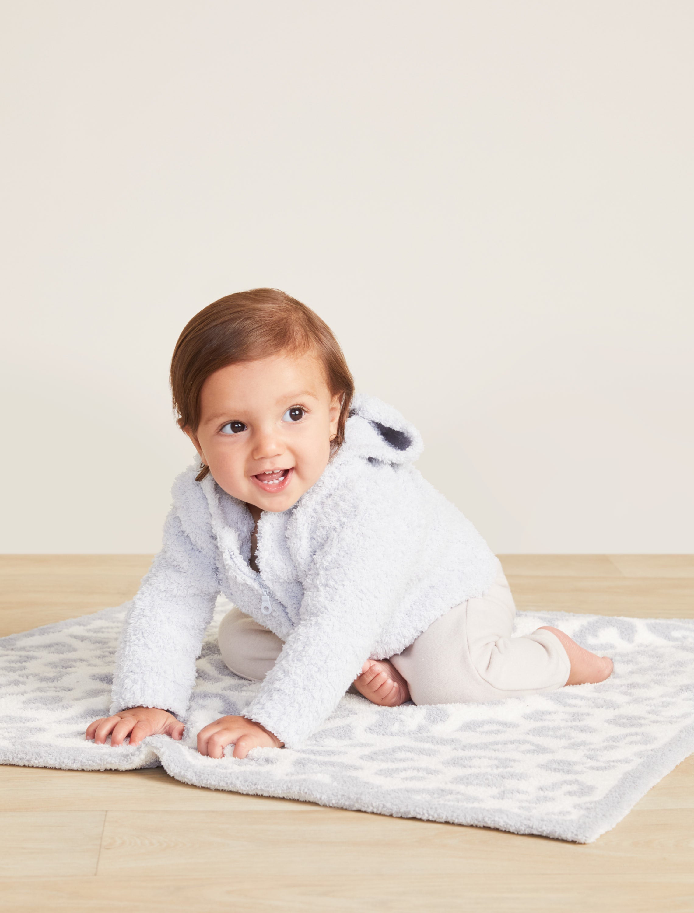 Baby wearing Blue CozyChic Infant Hoodie by Barefoot Dreams, ultra-soft baby pullover with hood, available at Be Charmed