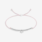 Pink bracelet with silver beads and heart charm on a white background. Available at Be Charmed