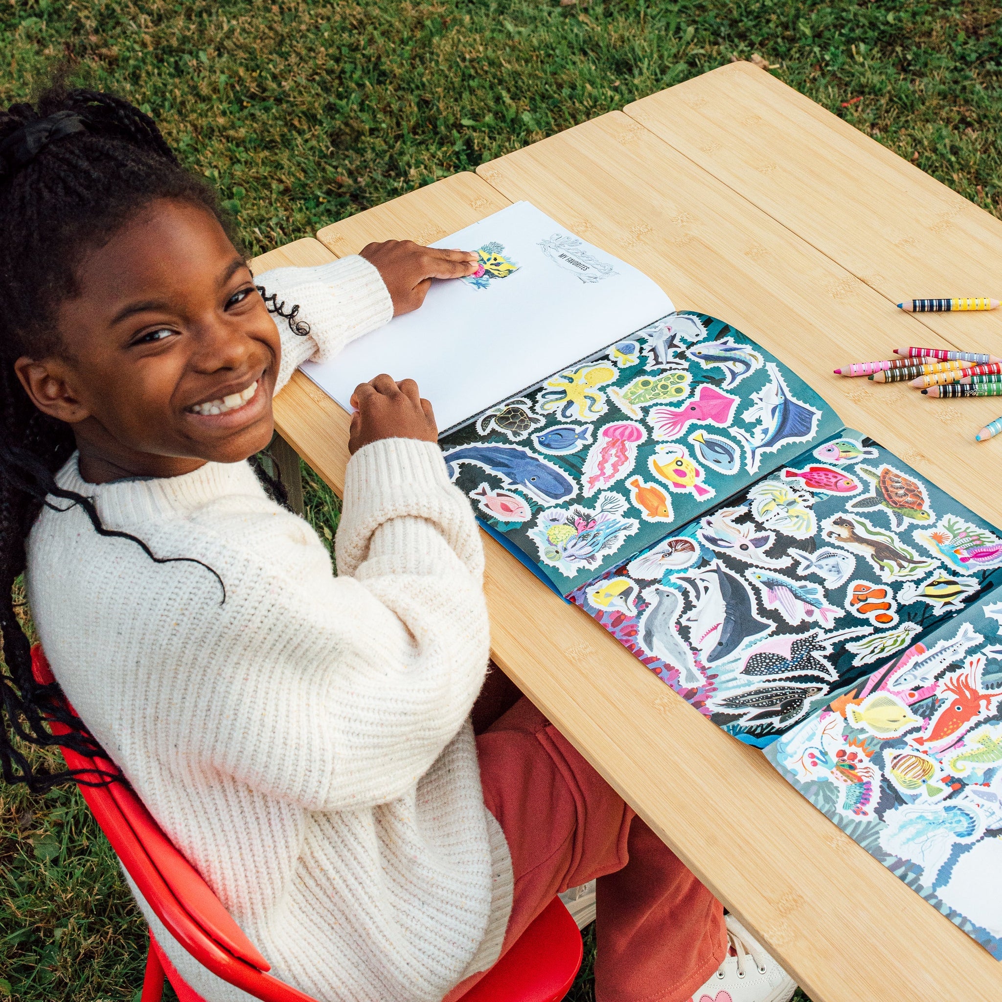 Child with eeBoo Learn To Draw – Under The Sea with Stickers, eco-friendly and educational drawing kit for kids. Available at Be Charmed.