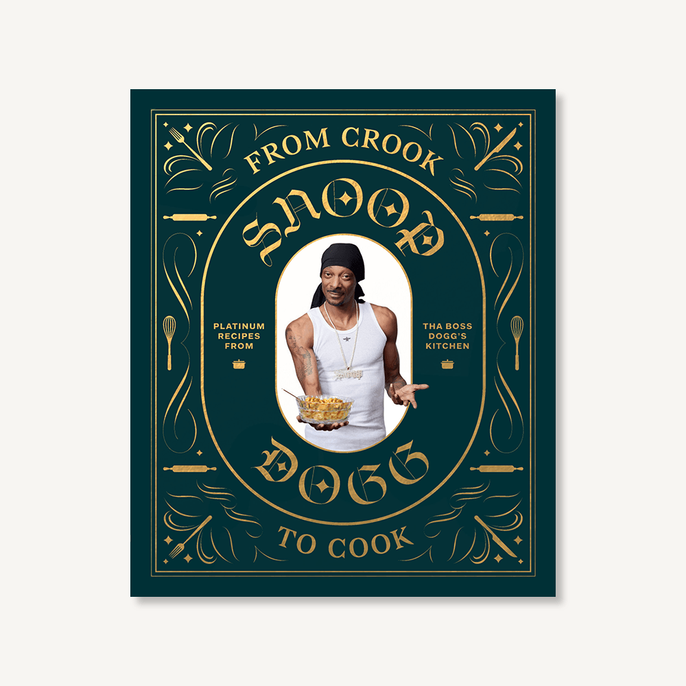 Hardcover cookbook From Crook to Cook by Snoop Dogg, ornate black and gold cover—Available at Be Charmed