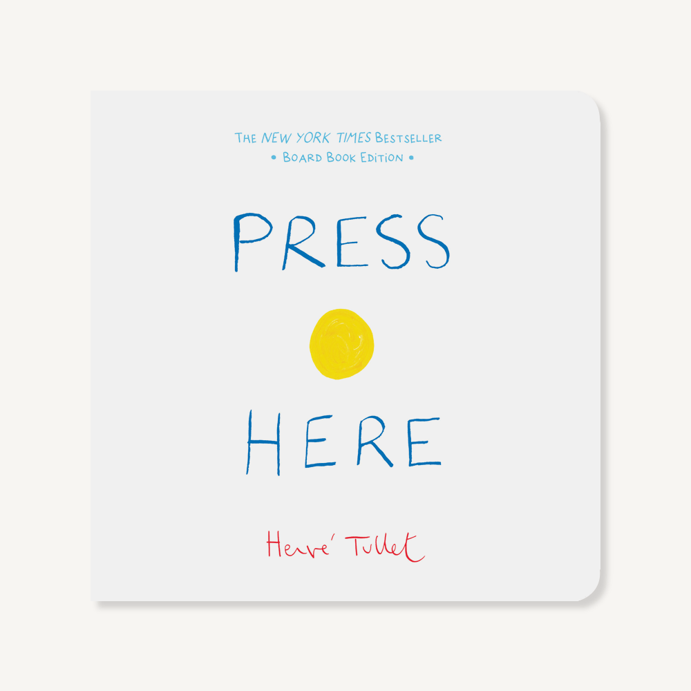 Press Here board book with colorful dots on cover—Available at Be Charmed