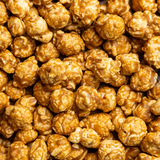 Close Up Picture of Poppy Handcrafted Popcorn Salted Caramel Snack Bag featuring buttery caramel popcorn with a touch of sea salt in a portable gourmet treat, available at Be Charmed