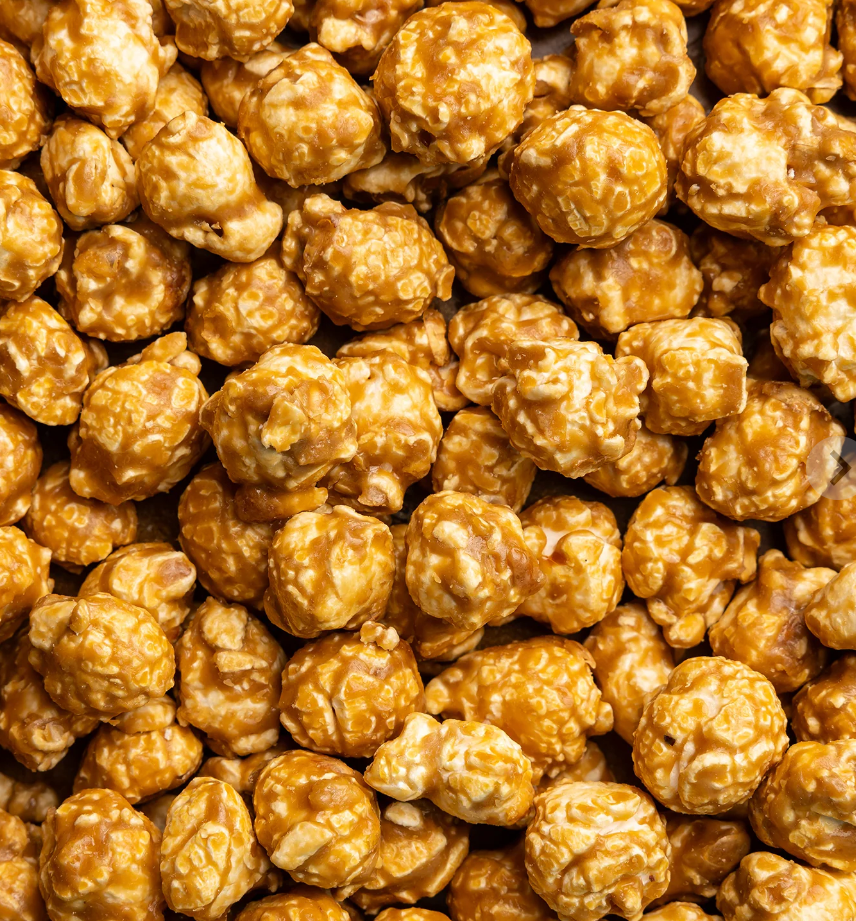 Close Up Picture of Poppy Handcrafted Popcorn Salted Caramel Snack Bag featuring buttery caramel popcorn with a touch of sea salt in a portable gourmet treat, available at Be Charmed
