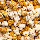 Close up Picture of Poppy Handcrafted Popcorn Asheville Mix Snack Bag with a gourmet cheddar and caramel blend in a portable, sweet-and-savory snack, available at Be Charmed