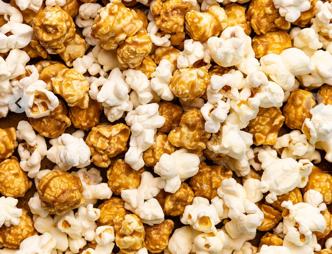 Close up Picture of Poppy Handcrafted Popcorn Asheville Mix Snack Bag with a gourmet cheddar and caramel blend in a portable, sweet-and-savory snack, available at Be Charmed