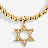 Gold beaded necklace with a Star of David pendant on a white background. Available at Be Charmed