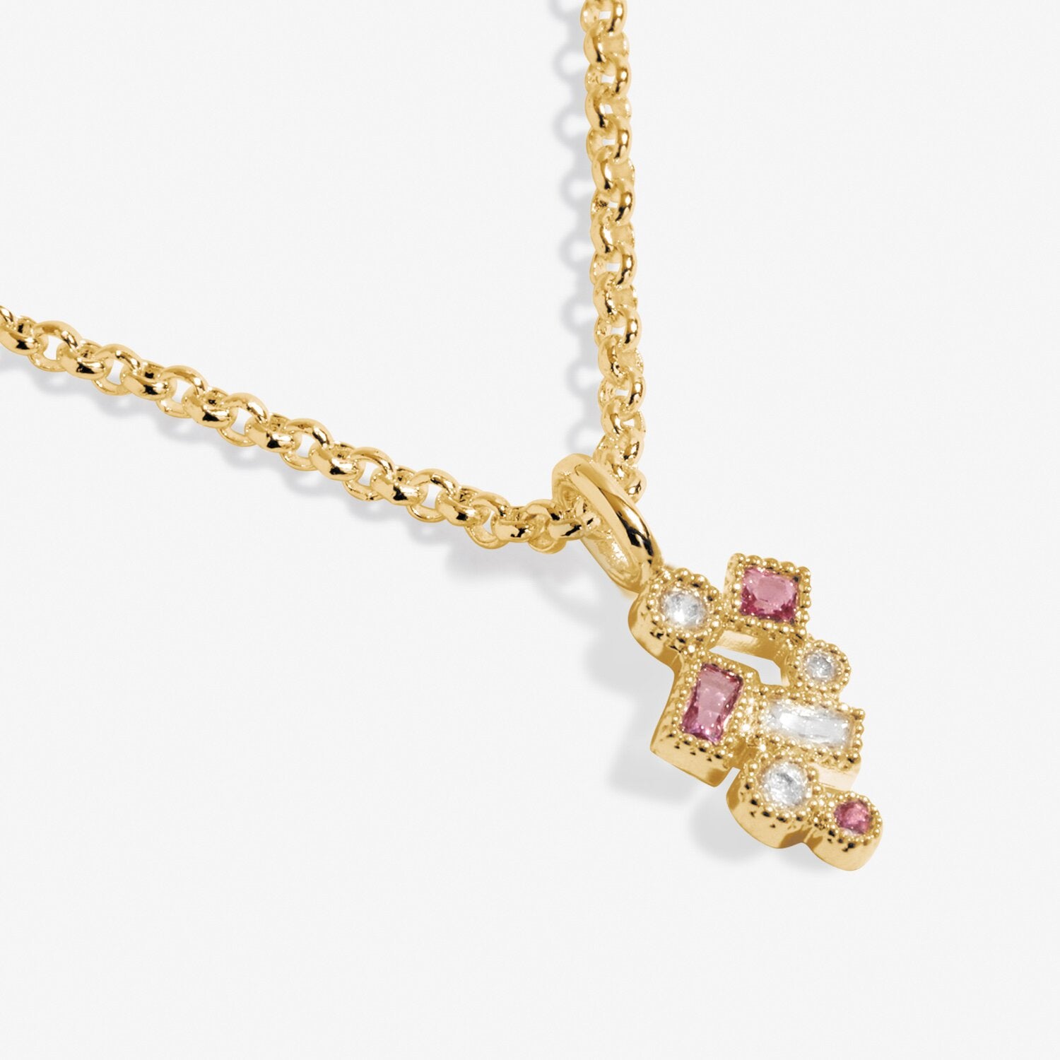 Gold necklace with a decorative pendant featuring pink gemstones on a white background. Available at Be Charmed