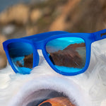 Close up of Goodr Falkor's Fever Dream Sunglasses featuring blue on blue frames and polarized lenses, inspired by whimsical fantasy and built for comfort, available at Be Charmed