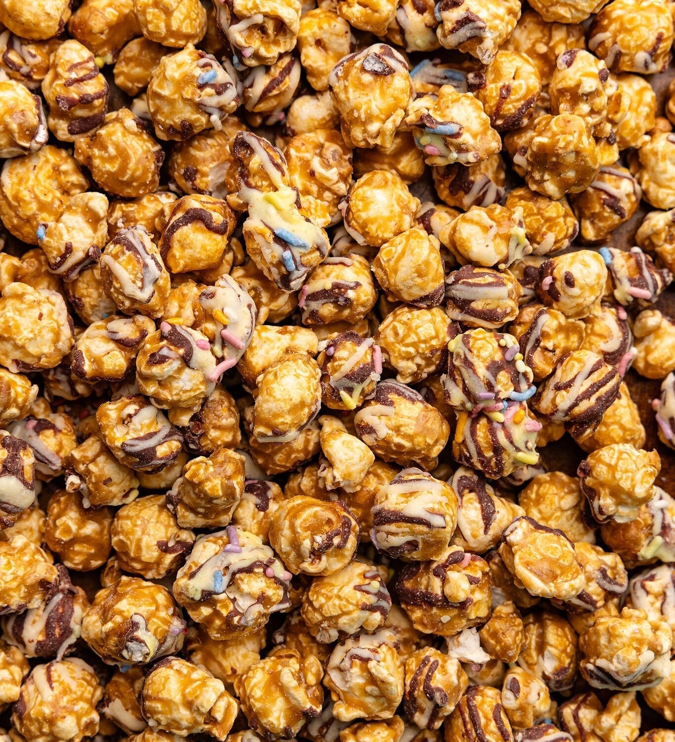Close up of Poppy Handcrafted Popcorn Birthday Confetti colorful gourmet popcorn with festive sprinkles. Available at Be Charmed