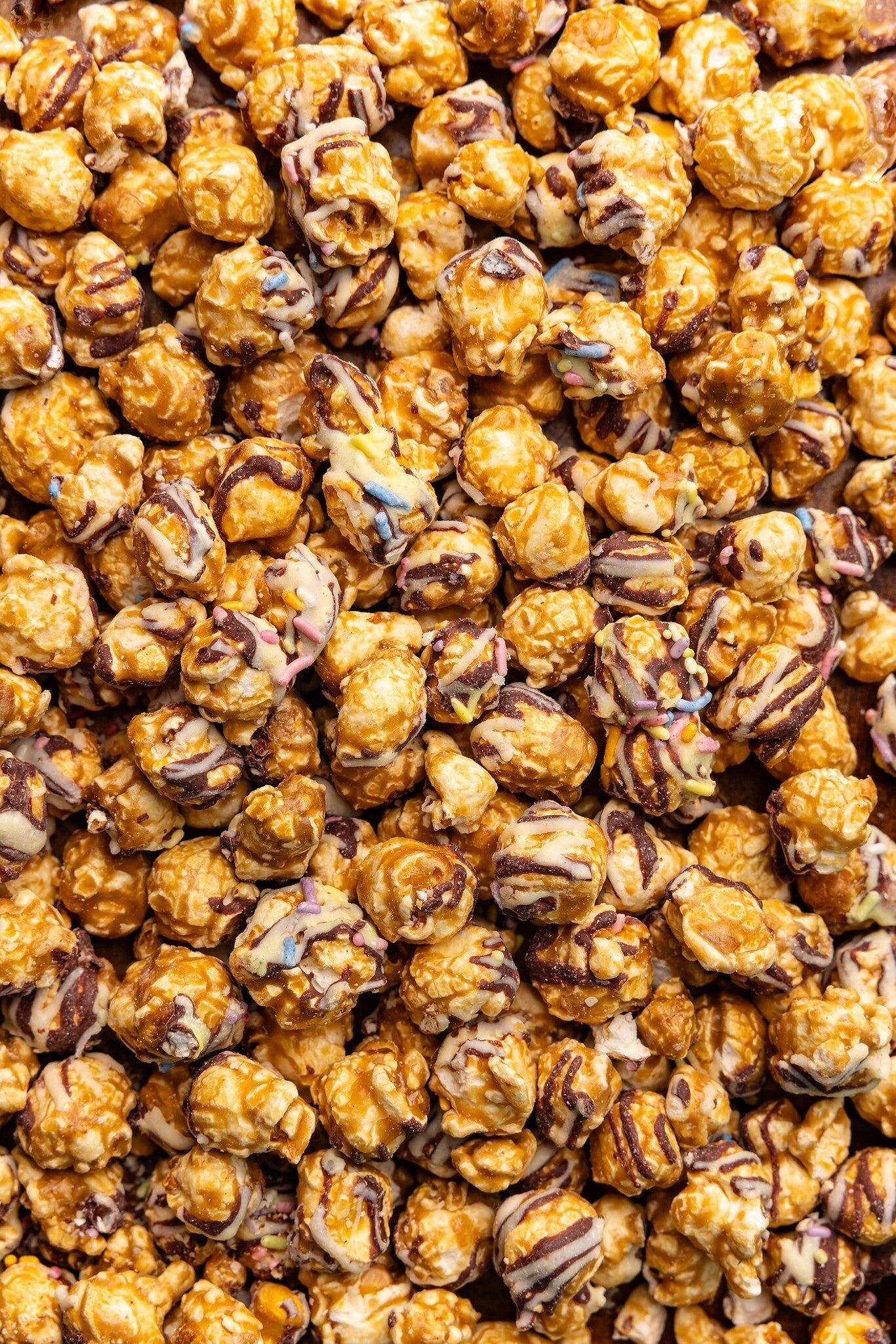 Close up of Poppy Handcrafted Popcorn Birthday Confetti colorful gourmet popcorn with festive sprinkles. Available at Be Charmed