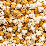 Close up picture of Poppy Handcrafted Popcorn Asheville Mix with a savory cheddar and sweet caramel blend in a small-batch gourmet snack, available at Be Charmed