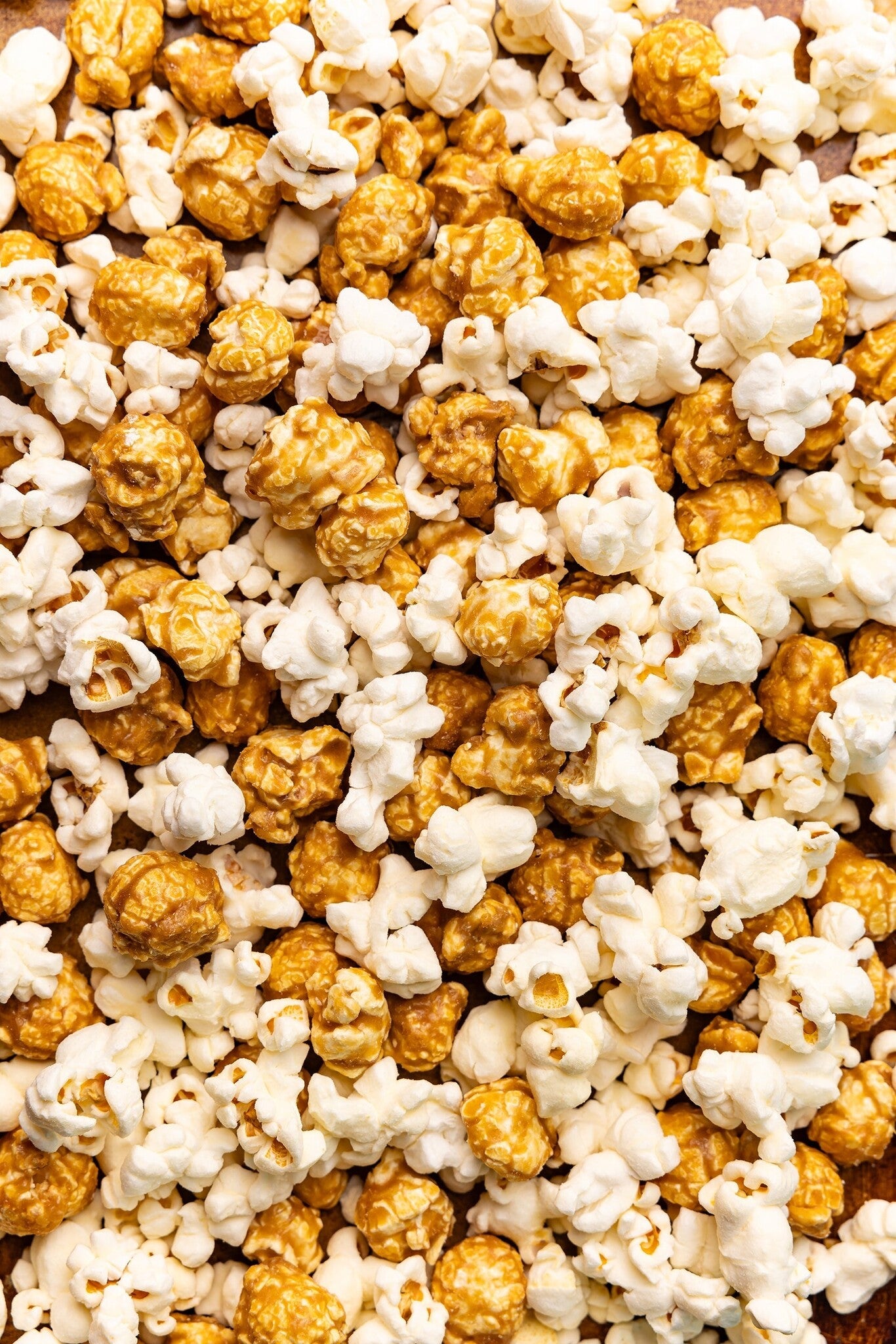 Close up picture of Poppy Handcrafted Popcorn Asheville Mix with a savory cheddar and sweet caramel blend in a small-batch gourmet snack, available at Be Charmed