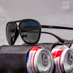 Close up view Operation Blackout Goodr sunglasses with all-black polarized lenses and matte black no-slip frames—sleek performance shades; available at Be Charmed