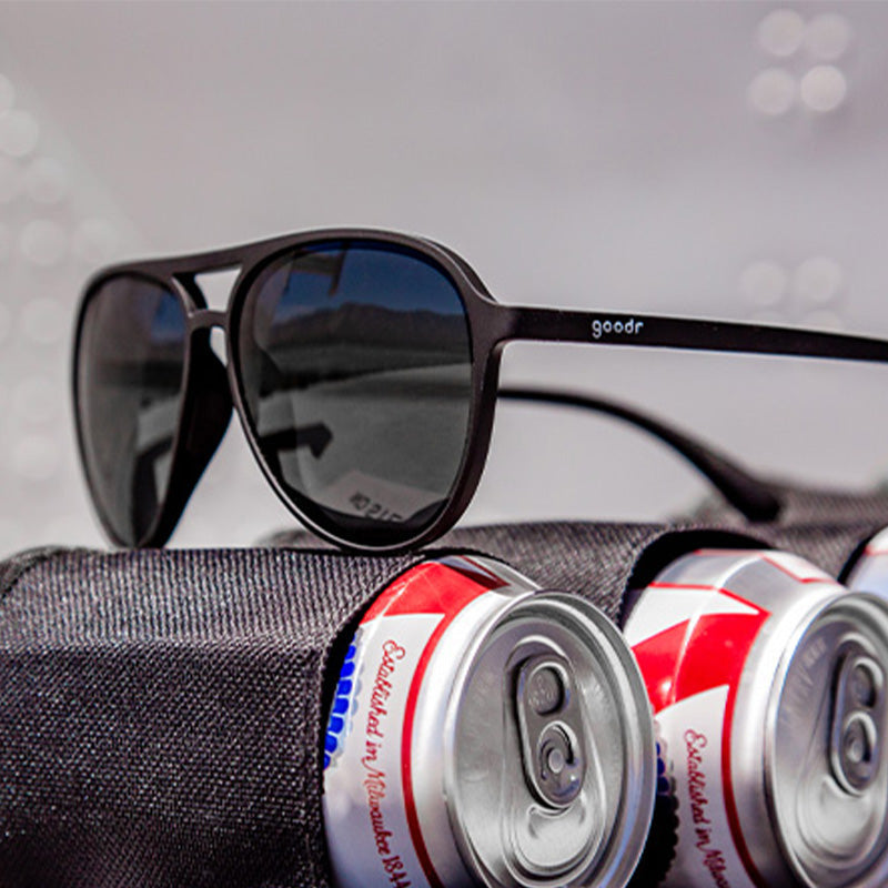 Close up view Operation Blackout Goodr sunglasses with all-black polarized lenses and matte black no-slip frames—sleek performance shades; available at Be Charmed