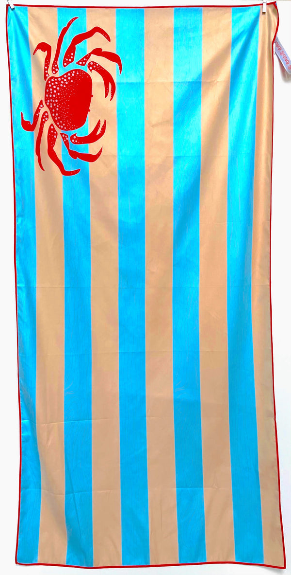 32″×64″ Clutch Towels “Feeling Crabby” oversized towel with bright red crab print, perfect for beach days or poolside. Available at Be Charmed