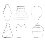 Cookie Cutters for Creative Brands Birthday cookie cutter set in a magnetic book-style box with 6 stainless steel shapes (cake, balloon, candle, present, party hat, heart) and a lemon sugar cookie recipe inside lid—Available at Be Charmed