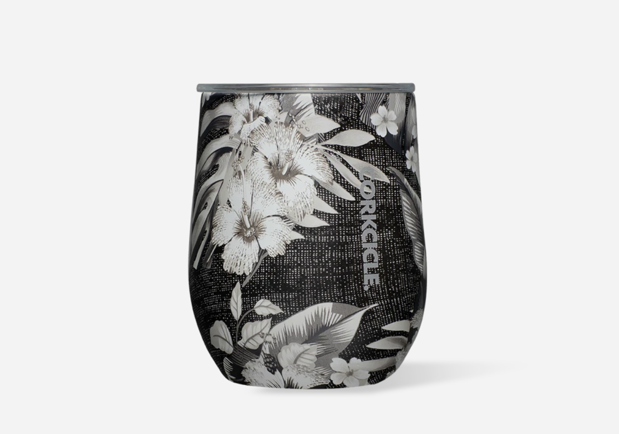 Corkcicle 12oz Stemless in Black Luau – tropical-inspired triple-insulated stainless steel tumbler featuring a vibrant floral design over a black background. Includes a clear, spill-resistant lid. Keeps drinks cold for 9+ hours or hot for 3+. Perfect for wine, cocktails, or coffee. Available at Be Charmed.