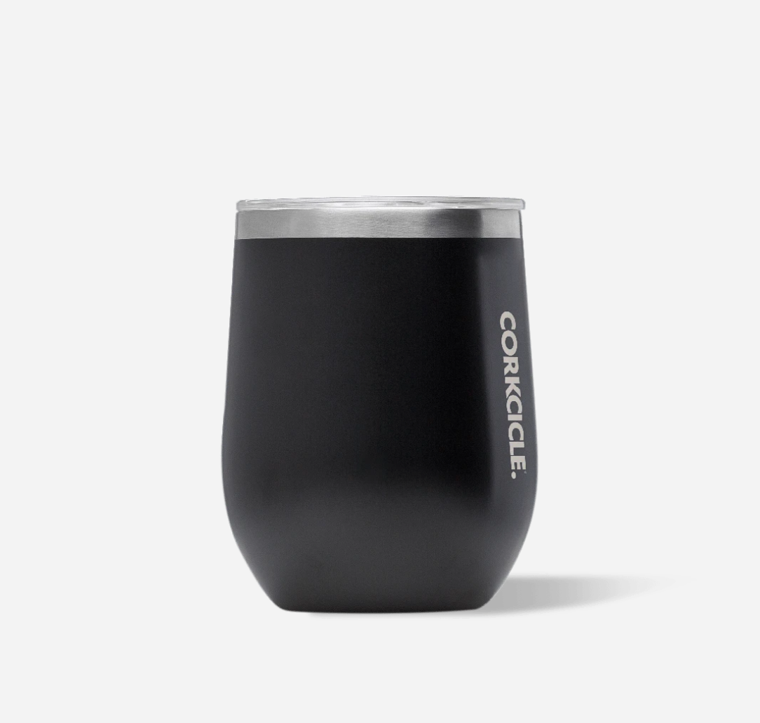 Corkcicle 12oz Stemless in Matte Black – triple-insulated stainless steel tumbler with a sleek matte black finish. Includes a clear, spill-resistant lid. Keeps beverages cold for 9+ hours or hot for 3+. A versatile and modern cup for wine, coffee, or cocktails. Available at Be Charmed.